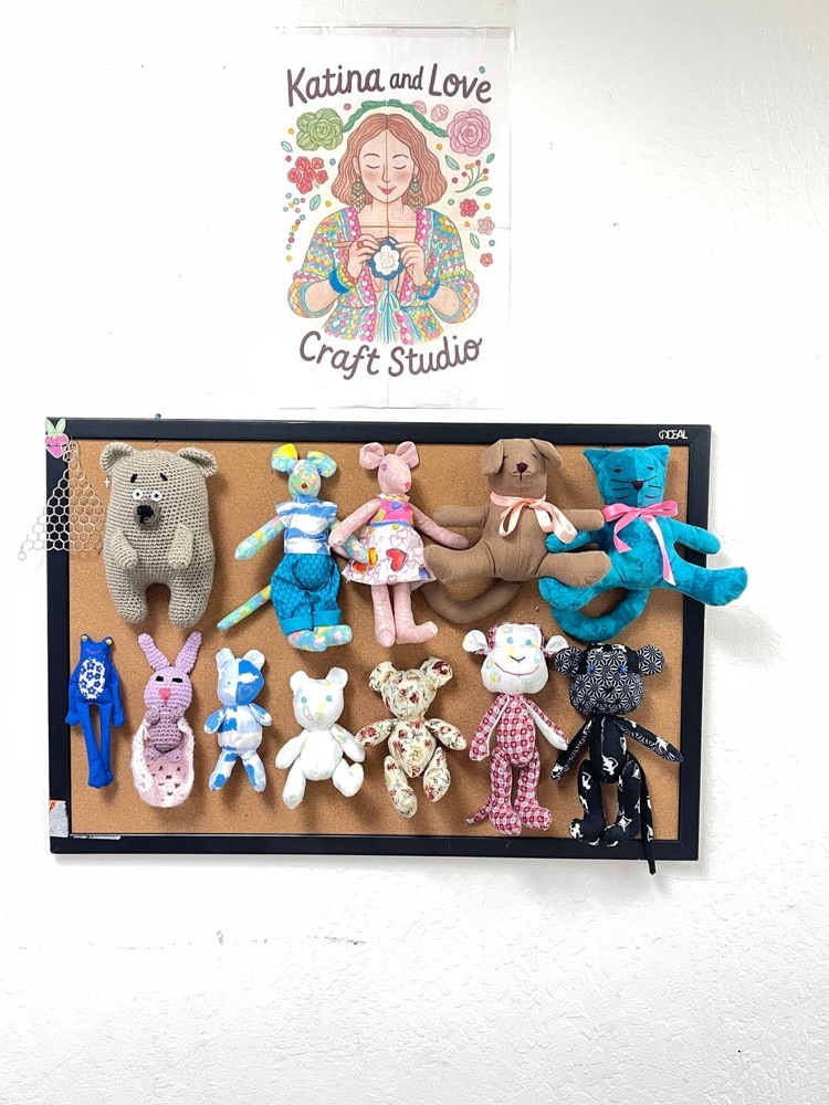 Display board of handmade stuffed animals at the studio