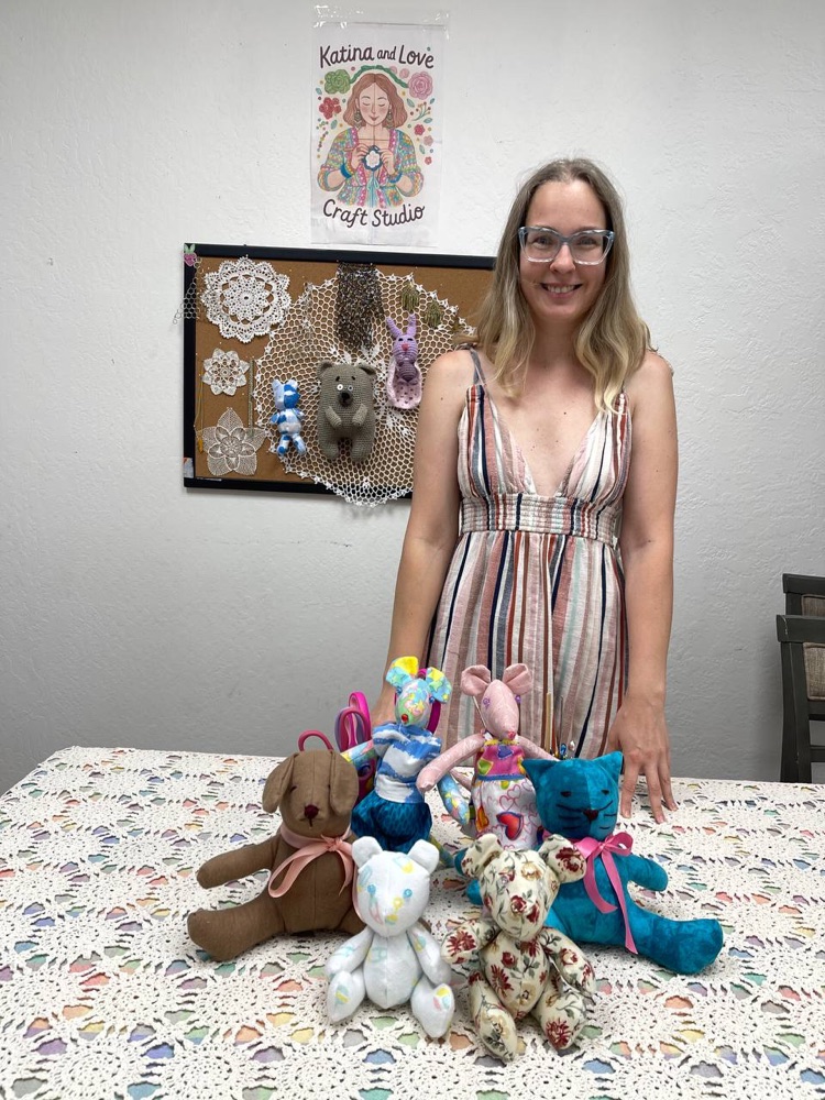 Instructor with finished handmade toys in the studio
